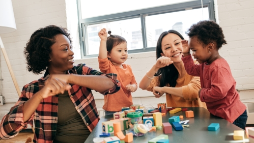 two teachers playing with two preschool children