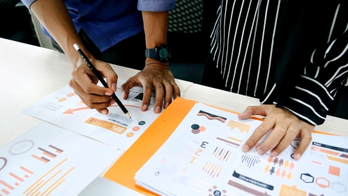 two colleagues reviewing data on paper