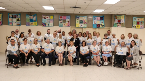 Group photo of people with the same tshirt on after a meeting