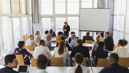 group of adult learners in training room with instructors