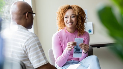 female college student sitting with adult counselor