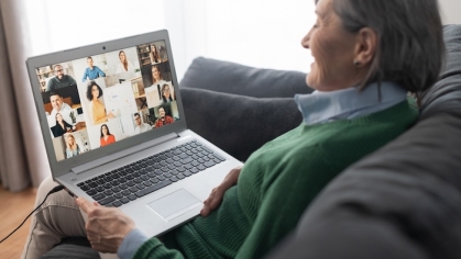 Woman on couch on a virtual meeting