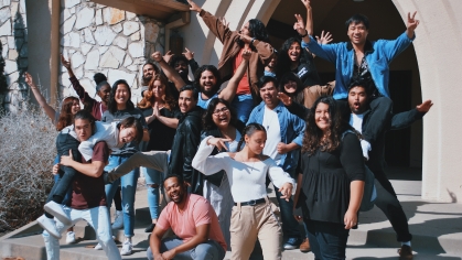 large group of college students celebrating outside