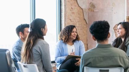 female counselor talking to small group