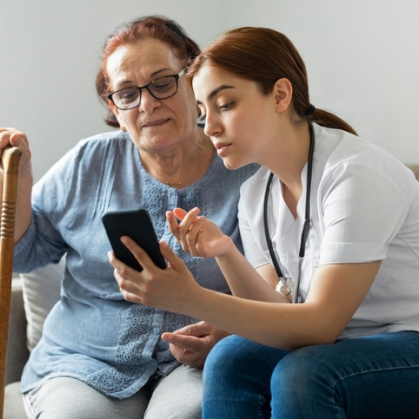 Girl and woman looking at smartphone