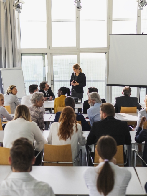 group of adult learners in training room with instructors