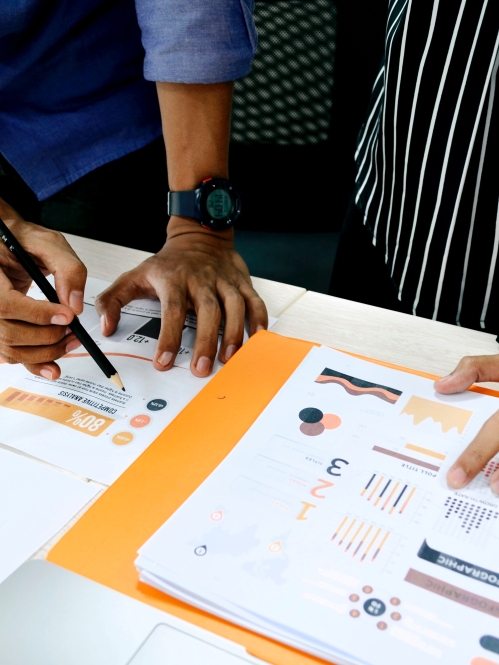 two colleagues reviewing data on paper