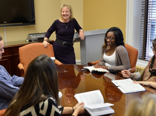 students and faculty sitting around conference table