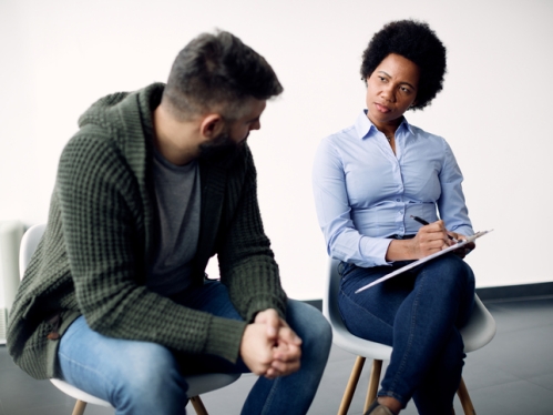 Social worker sitting with client