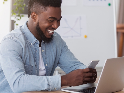 Man with iphone and laptop