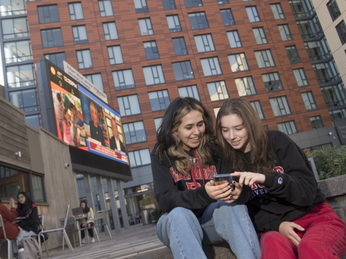 Two student viewing smart phone