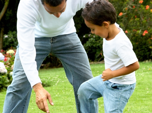 Father and son playing soccer
