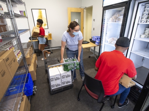 Deja Little, food pantry coordinator Gina Gohl and Glennae Brown, work in the Newark Food Pantry, pantryRUN, housed in the Paul Robeson Campus Center