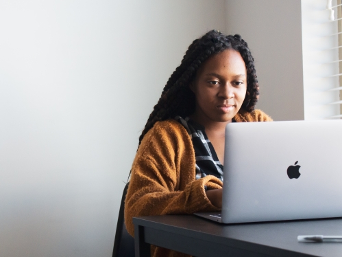 Female working at a desk with laptop open