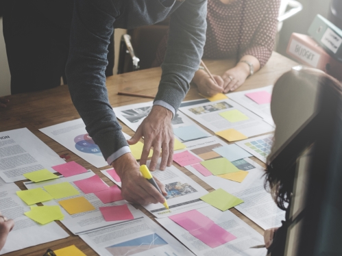 group of colleagues reviewing papers in workgroup